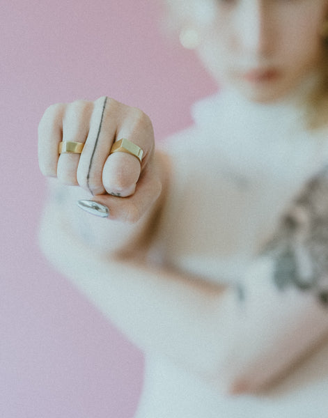 Pointed brass rings on an out of focus model in the background