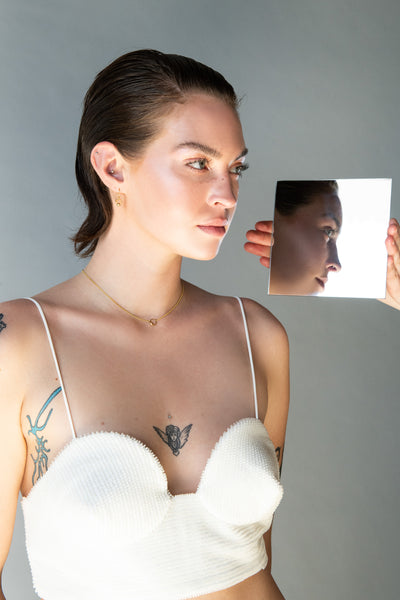 Model wearing gold choker and earrings