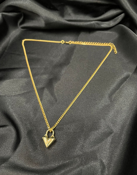 Gold heart locket choker on a black silk background