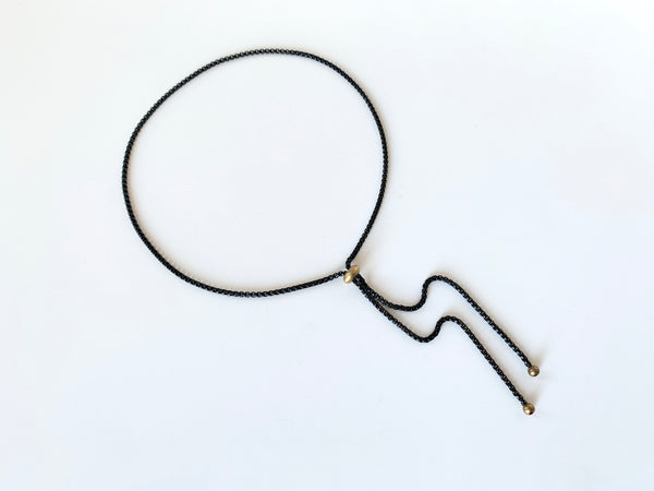 Black rolo chain bolo tie with gold slide bead and round bolo tips