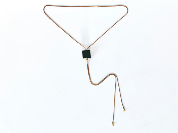 Black cube bolo tie necklace with round brass bolo tips