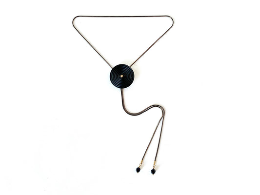 Black bolo tie necklace with circle medallion and goldstone bolo tips