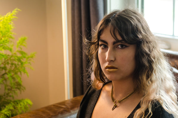 Model wearing gold fishbone choker