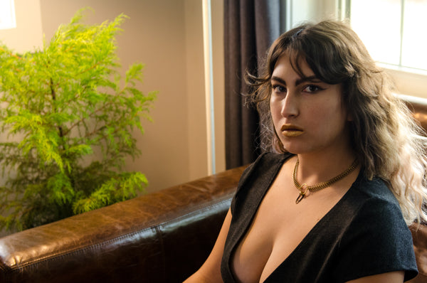 Model wearing gold fishbone choker
