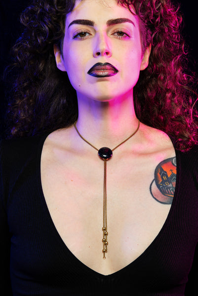 Model wearing blue goldstone pendant bolo tie necklace