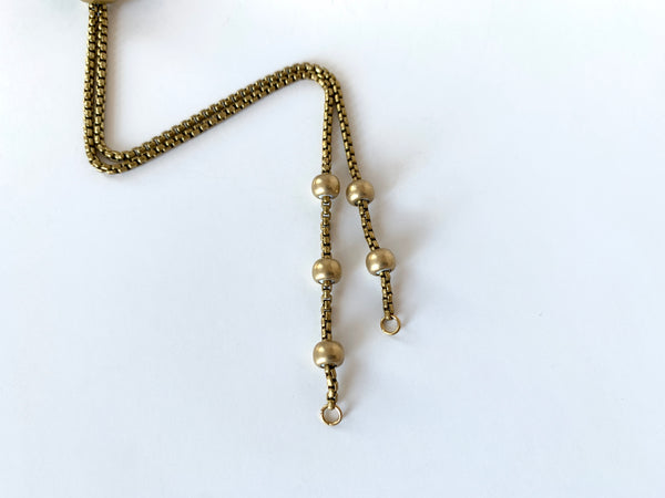 Close up of round gold bolo tie tips of bolo tie