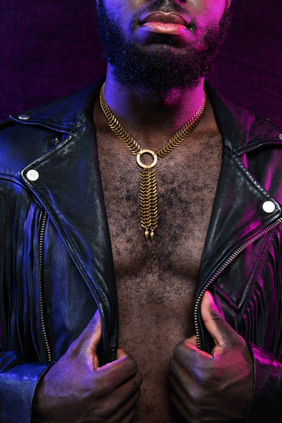 Model wearing fishbone choker with spike tassels and black leather jacket