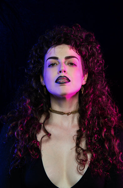 Front view of model wearing gold fishbone choker and chain link dangle earrings