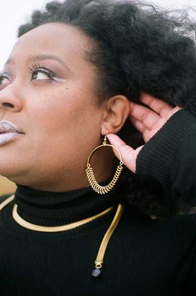 Thick chain earrings on a model