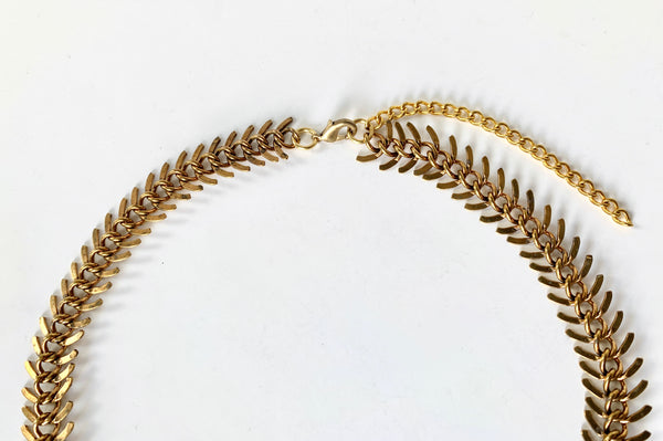 Close up of lobster clasp and extender chain of fishbone choker