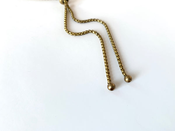 Round gold bolo tips of bolo tie