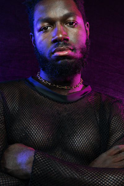 Model wearing gold chunky chain choker with arms crossed