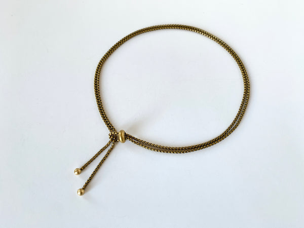 Rolo chain lasso style necklace with slide bead and round gold tips