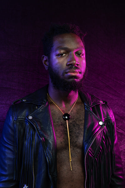 Model wearing onyx bolo tie and black leather jacket