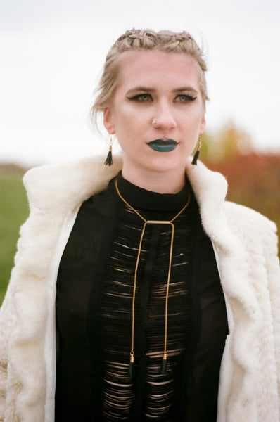 Model wearing adjustable gold necklace