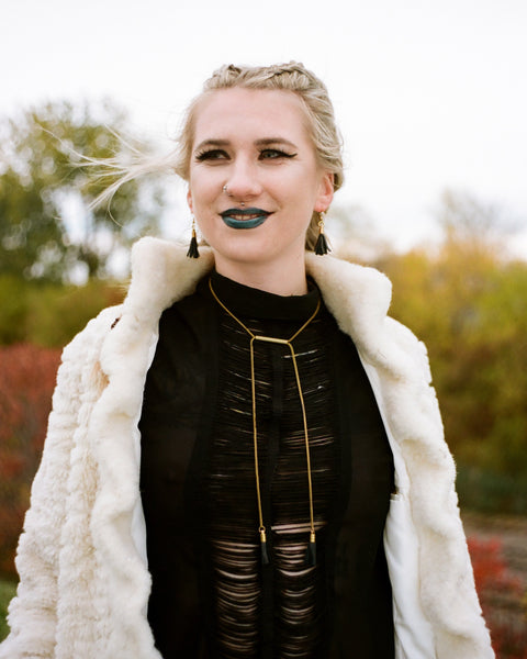 Model wearing brass bar necklace