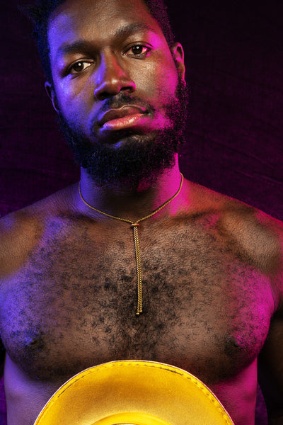 Model wearing gold bolo tie necklace