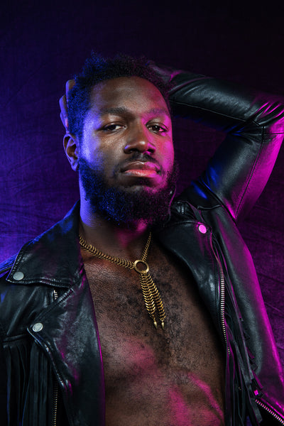 Side view of model wearing o ring choker and leather jacket