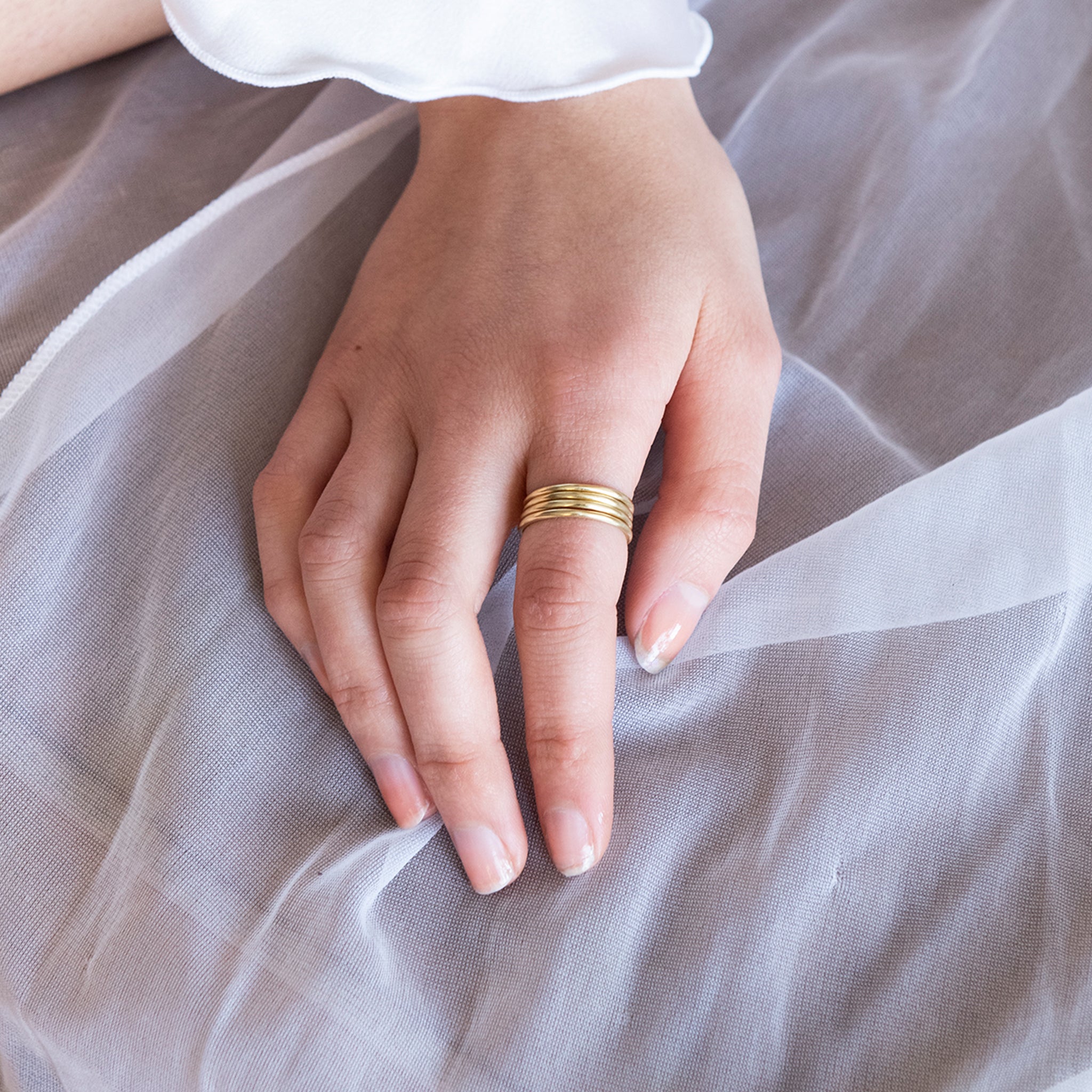 Brass stacking rings on a models hand