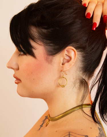 Side view of model wearing beaded hoop earrings and fern chain choker