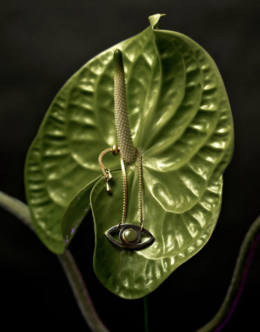 Green resin eye bracelet on a leaf
