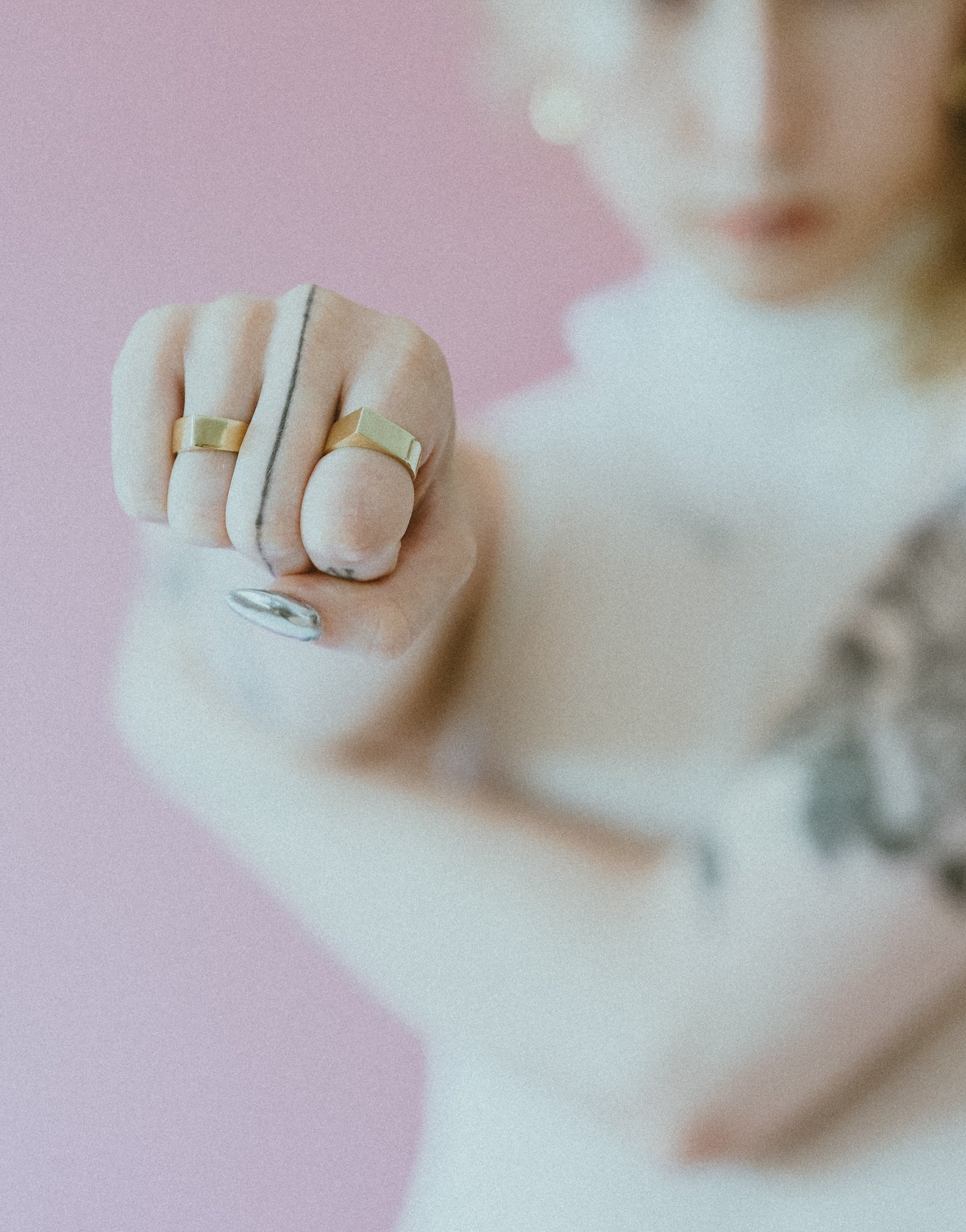 Pointed brass rings on an out of focus model in the background