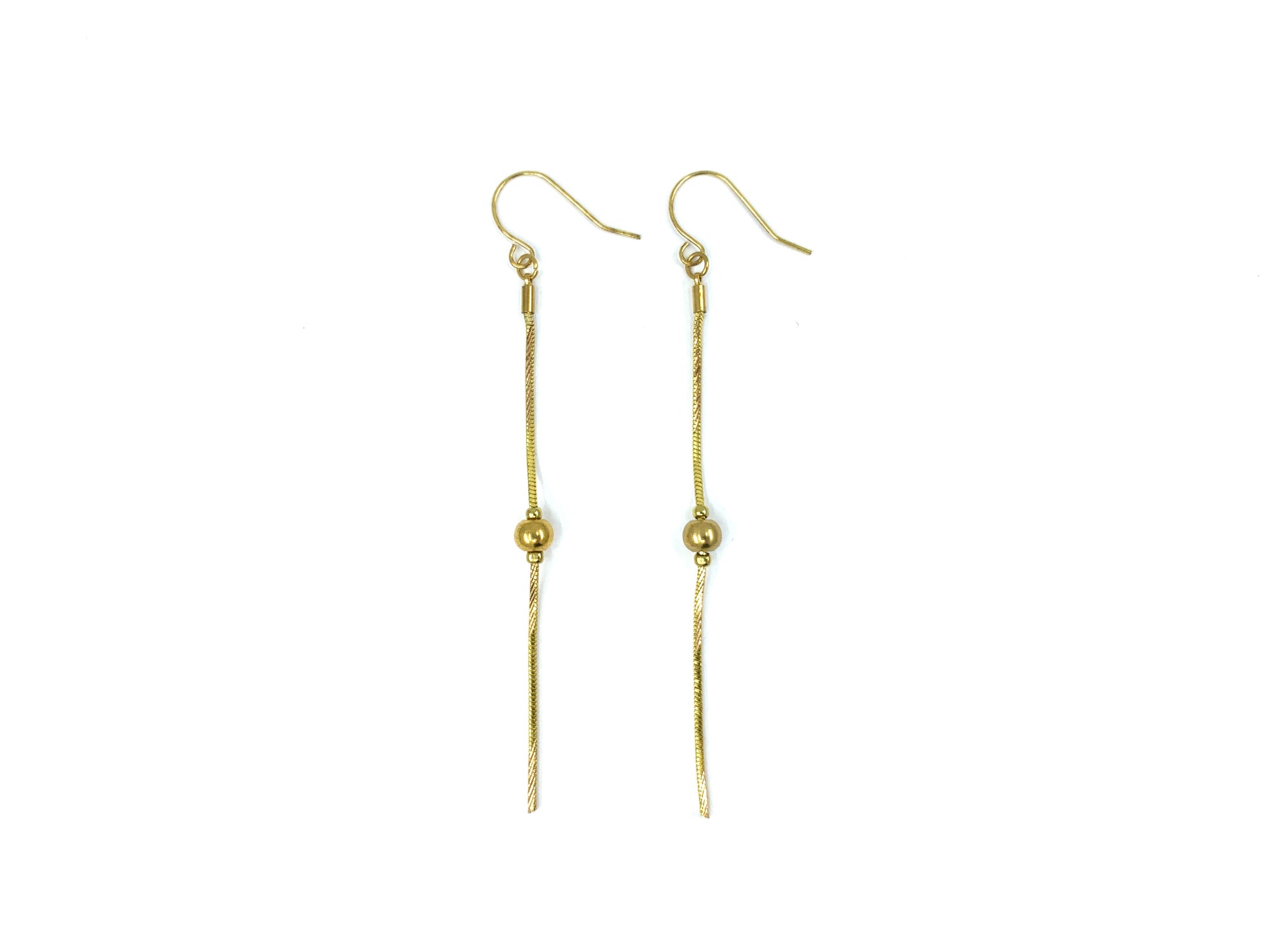 Gold snake chain drop earrings on a white background