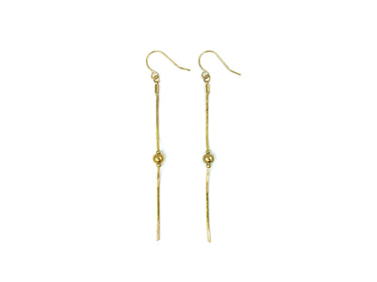 Gold snake chain drop earrings on a white background