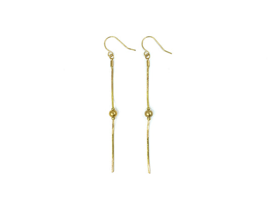 Gold snake chain drop earrings on a white background