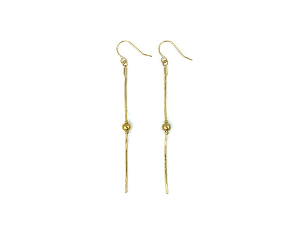 Gold snake chain drop earrings on a white background