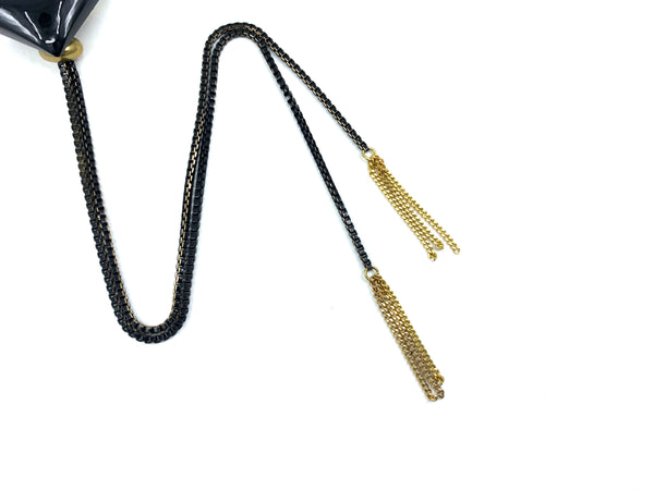 Gold tassel bolo tie tips on a white background