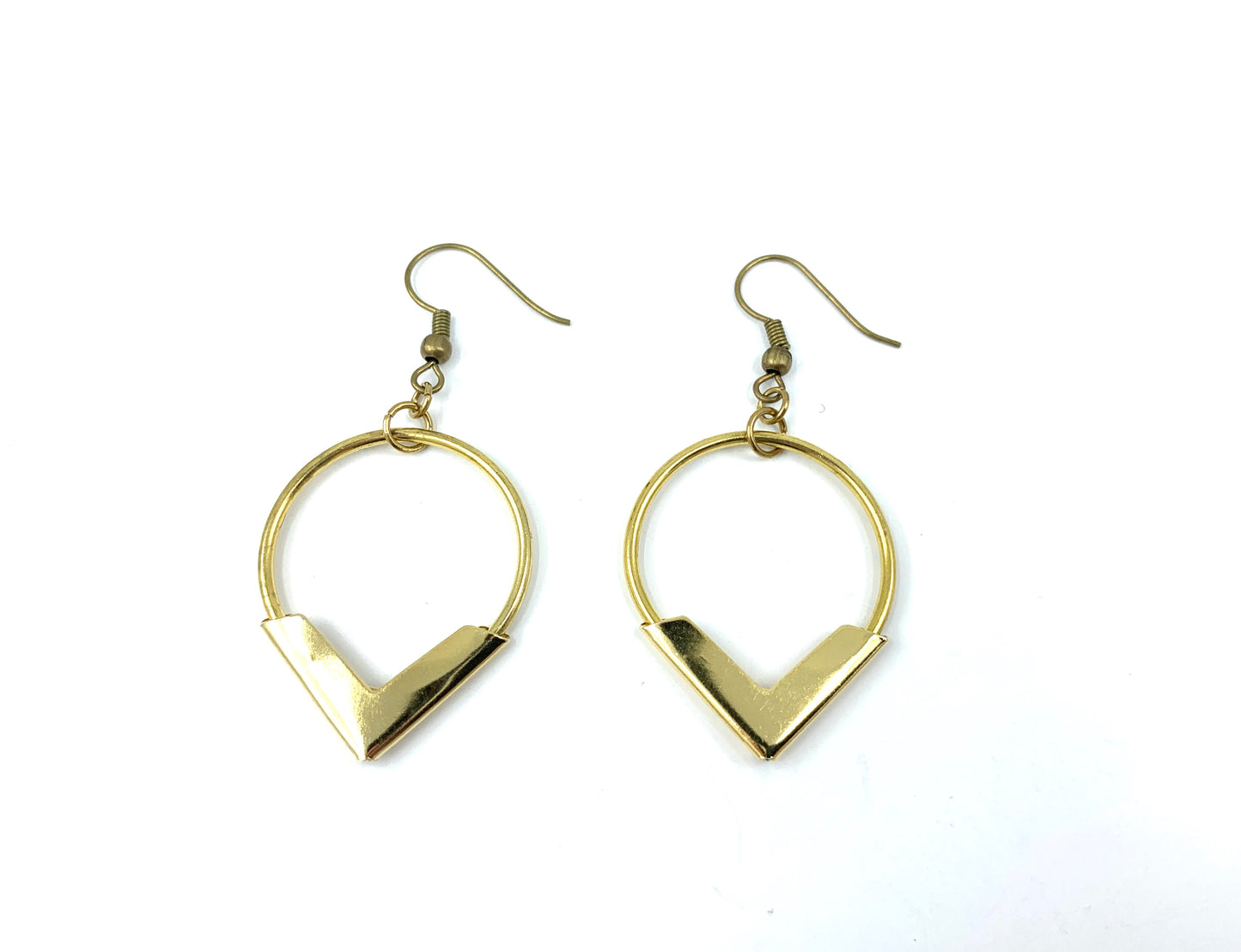 Brass hoop earrings on a white background