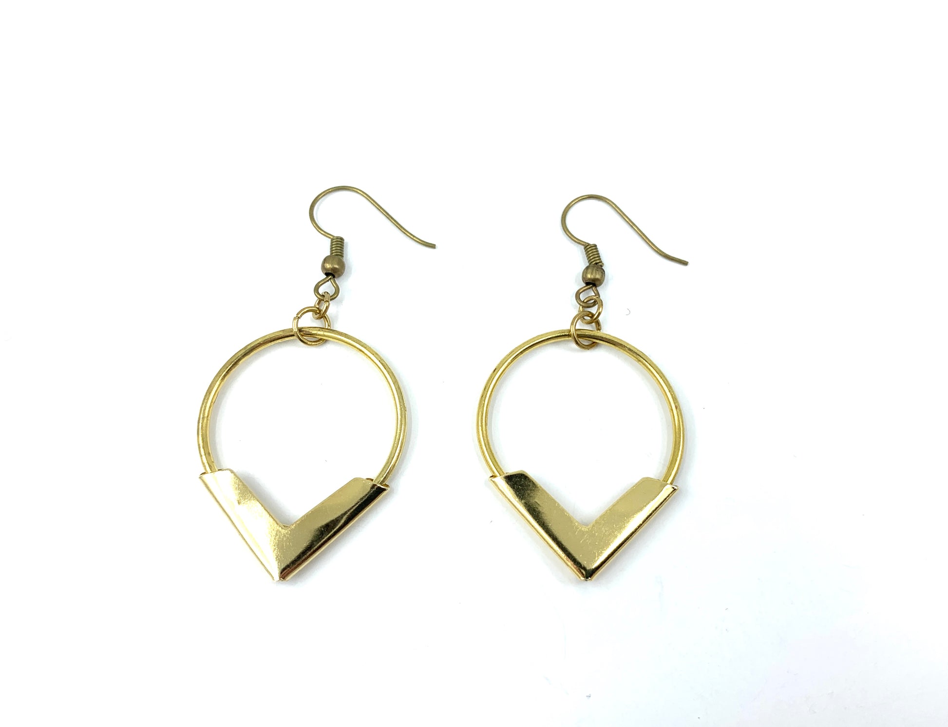 Brass hoop earrings on a white background