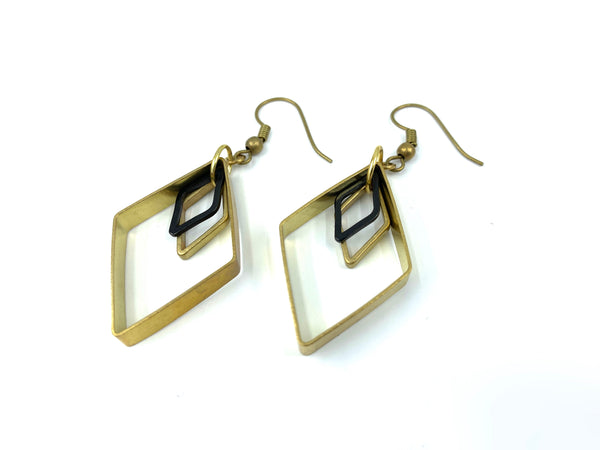 Black handmade brass diamond earrings on a white background
