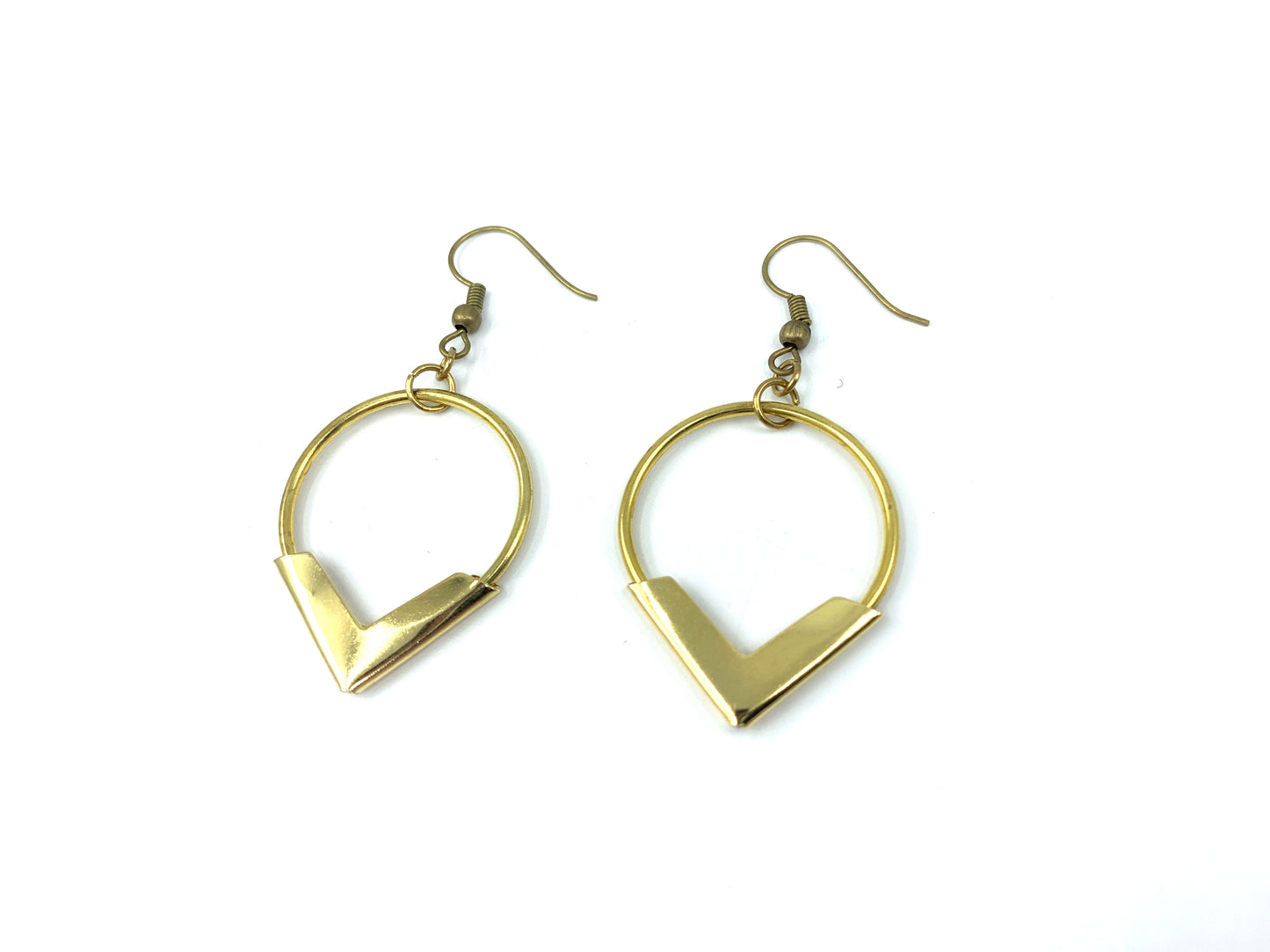 Angled view of gold hoop earrings on a white background