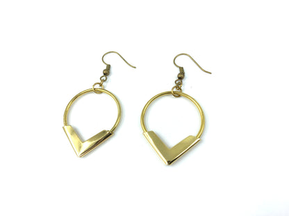 Angled view of gold hoop earrings on a white background