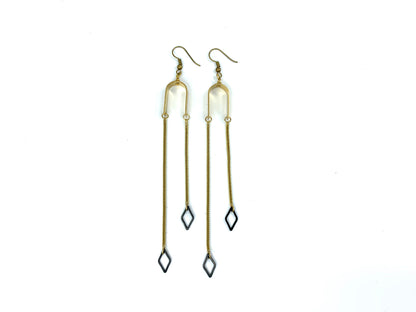 Asymmetric black and gold dangle earrings on a white background