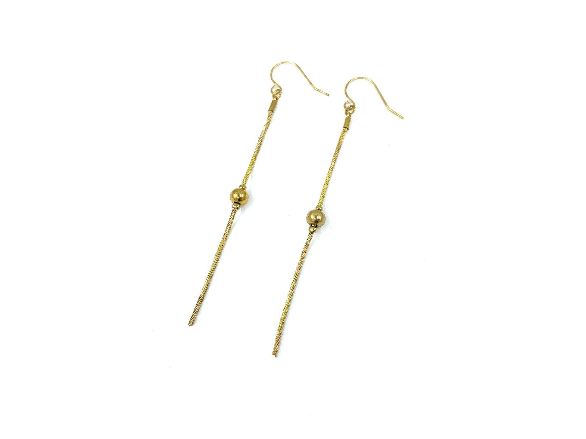 Gold bead drop earrings on a white background