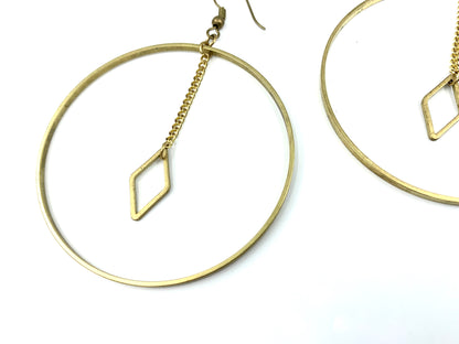 Close-up of diamond charm of large hoop earrings