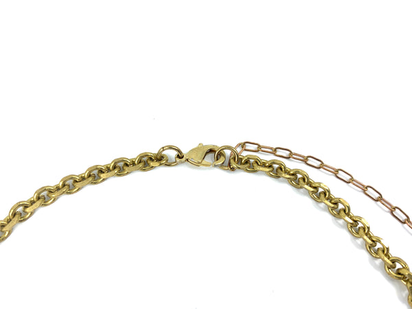 Close-up of lobster clasp, thick cable chain and extender chain of choker on a white background