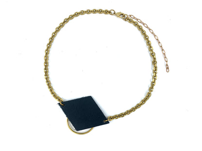 Recycled leather choker necklace with an o-ring and  a thick faceted cable chain on a white background