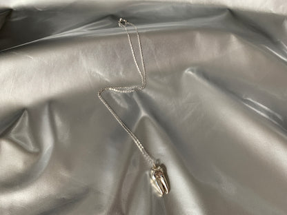 Sterling silver tooth choker on a silver background