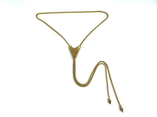 Gold sunburst bolo tie with foxtail snake chain and spike bolo tie tips on a white background