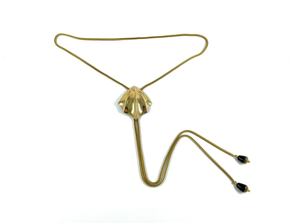 Gold fin bolo tie with foxtail snake chain and black bead bolo tips on a white background