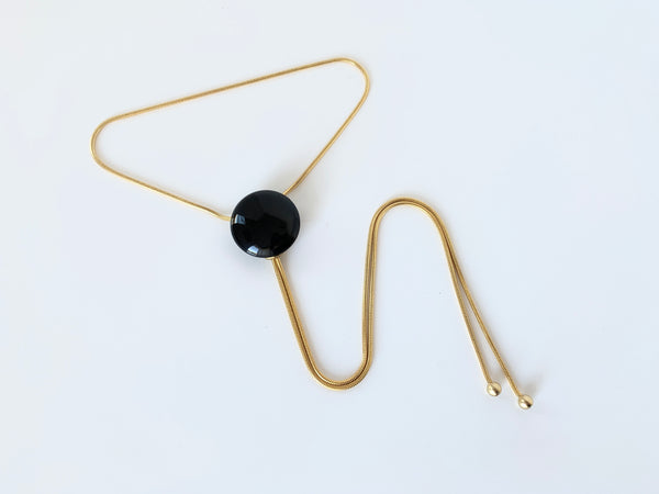 Bolo tie with onyx pendant, gold chain and gold bolo tips