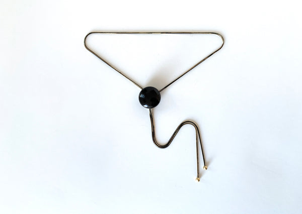 Bolo tie with black onyx pendant, two-toned black and gold chain and gold bolo tips