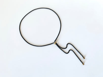 Black rolo chain bolo tie with gold slide bead and round bolo tips