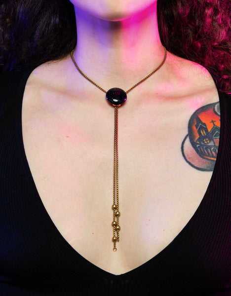 Close up of model wearing blue goldstone bolo tie