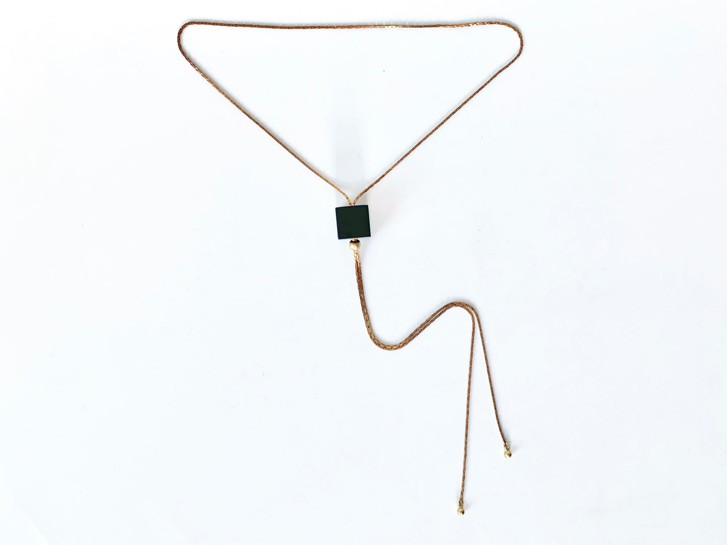 Black cube bolo tie necklace with round brass bolo tips