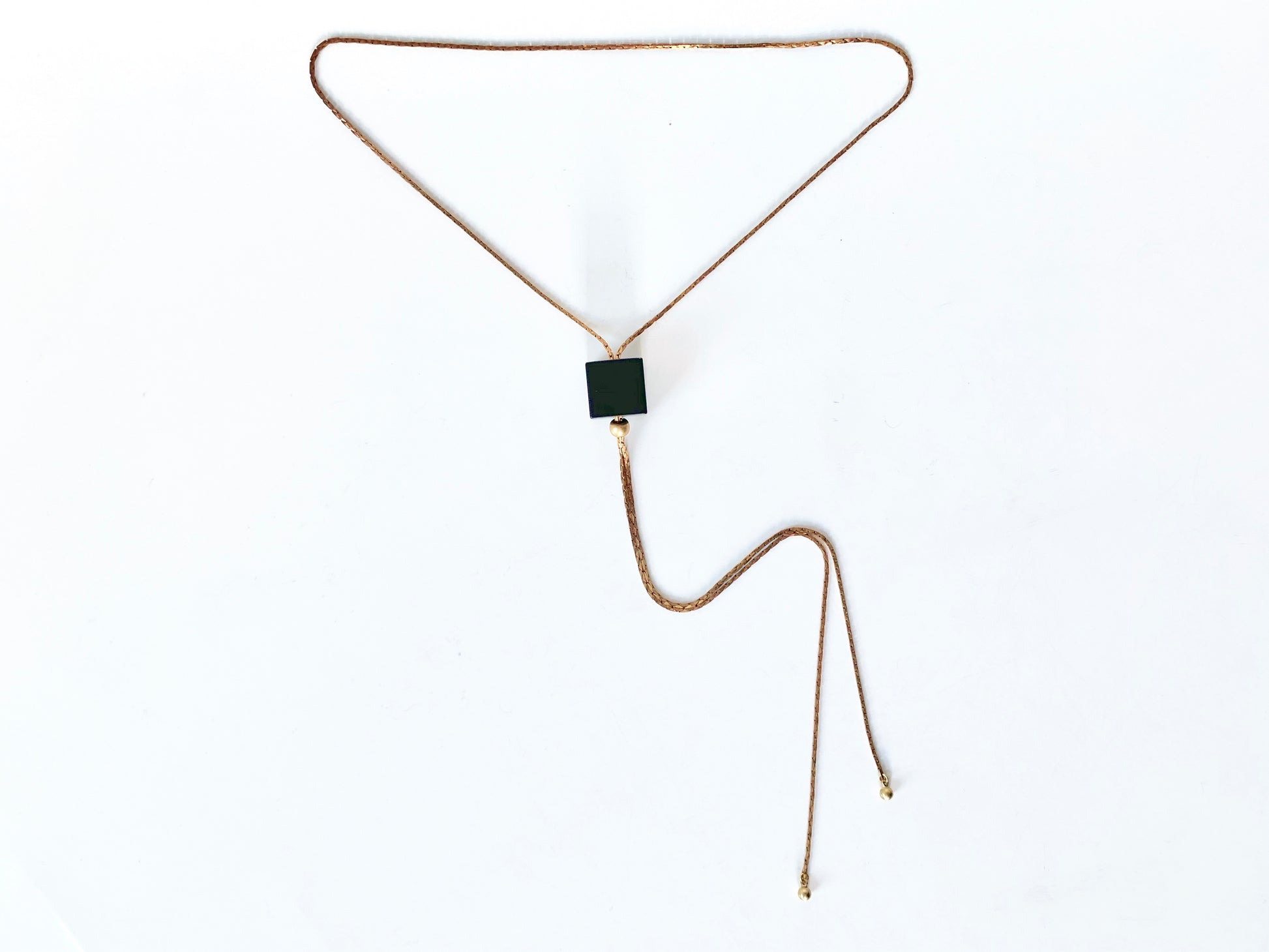 Black cube bolo tie necklace with round brass bolo tips